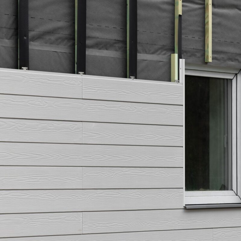 wood texture composite cladding installation on house facade